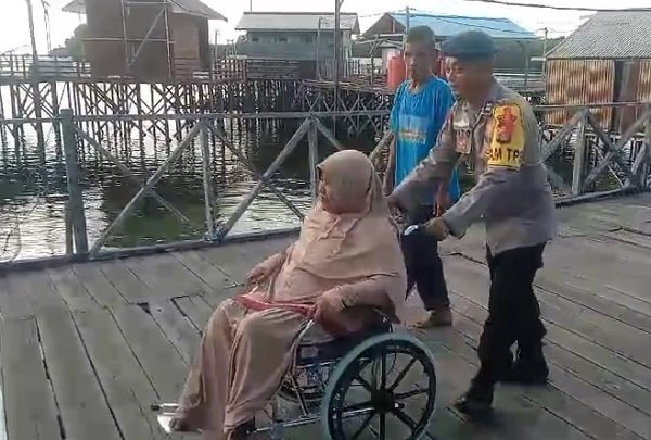 Dedikasi Polairud Bontang Bantu Ibu Sakit ke TPS Pemilu dengan Kursi Roda